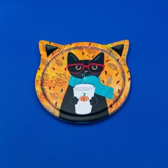 Cup coaster with a cat design on a blue background