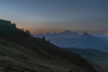 Obraz premium alpine landscape in early morning before sunrise with layers of mountains in the background in Damüls Bregenzer Wald in Vorarlberg Austria