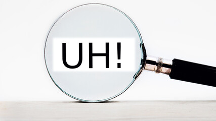 uh lettering on through a magnifying glass on a light background