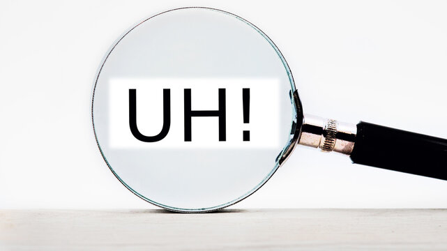 uh lettering on through a magnifying glass on a light background