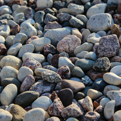 Macro closeup of river rock, a natural stone product commonly used in landscaping and outdoor design.  Background with copy space