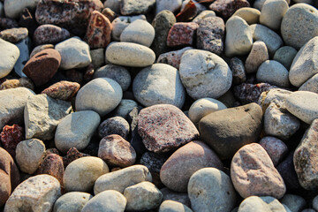 Closeup of river rock, a natural stone product commonly used in landscaping and outdoor design.  Background with copy space