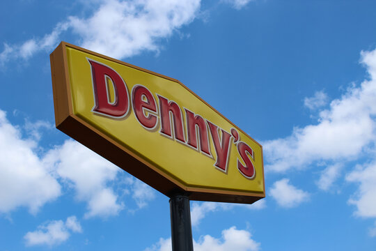 Rothschild, WI (USA) - August 14, 2025: A Denny's sign isolated against a beautiful sky. The chain is known for its classic American diner fare, breakfast items, and comfort food. Editorial Use Only.