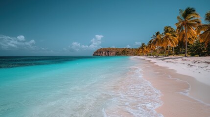 Fototapeta premium Pristine tropical beach. Turquoise water laps onto a pristine white sand beach, framed by swaying palm trees. A backdrop of a rocky shoreline and a partly cloudy sky