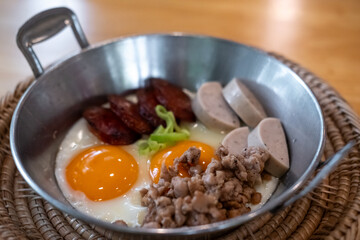 Thai style Skillet egg. A pan fried egg with toppings including Thai pork sausage, ground pork and Chinese sausage.