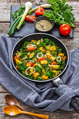 zucchini kale tomato saute sprinkled with sesame