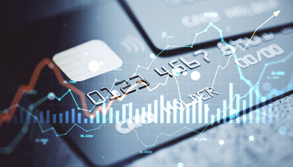 Credit and debit card close-up with financial data charts and graphs overlaid on light background showing modern digital banking concept.