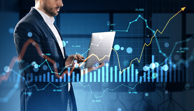 Businessman analyzing financial market data on laptop with rising chart overlay in modern office background, concept of growth and investment.