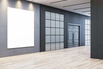 Modern office hallway with vertical blank poster on concrete wall under spotlights for signage,...