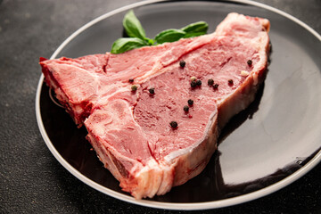 Raw steak T-bone fresh meat premium beef snack fresh delicious gourmet food background on the table rustic food top view copy space