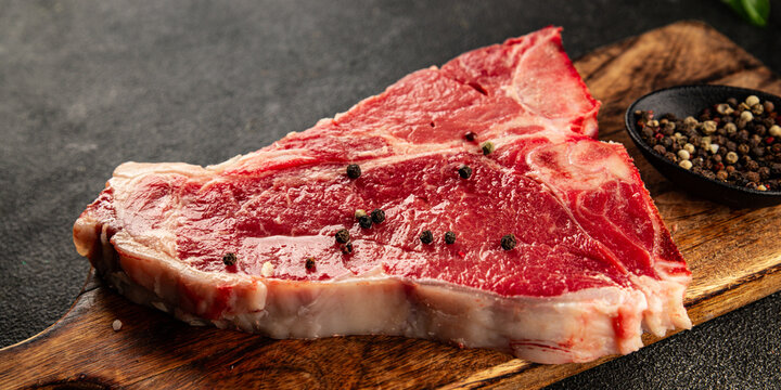 Raw steak T-bone fresh meat premium beef snack fresh delicious gourmet food background on the table rustic food top view copy space