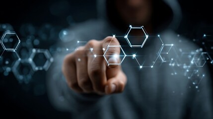 A hooded figure points at a glowing network of hexagons overlaid on a dark background. The digital display suggests data analysis and cybersecurity.