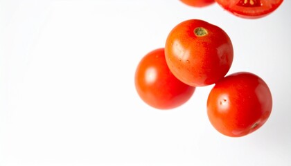 Whole and sliced fresh tomatoes in the air on a white background