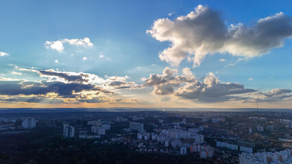 Scenic aerial view of cityscape with dramatic sunset sky and clouds