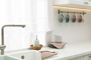 Clean dishware and waffle towels on countertop in kitchen