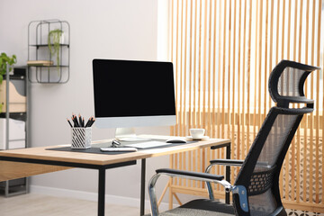 Stylish workplace with modern computer and stationery on wooden table in office