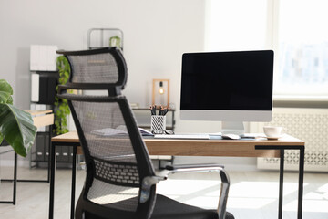 Stylish workplace with modern computer and stationery on wooden table in office