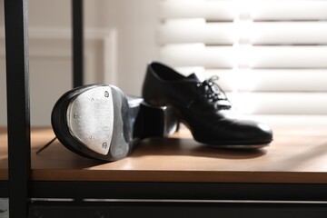 Pair of shoes for tap dance on cabinet indoors, closeup