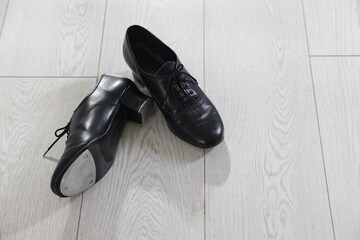 Pair of shoes for tap dance on floor, above view. Space for text
