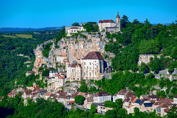 Buildings of the pilgrimage site of Rocamadour on a steep rocky cliff in the valley of the Alzou River in Quercy, France