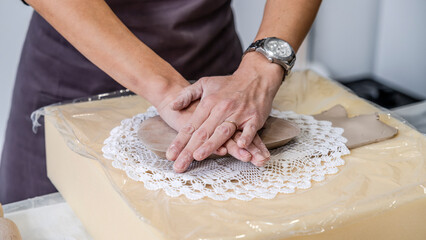 In an art studio with an environment adorned with artistic paintings in the background, a beautiful...