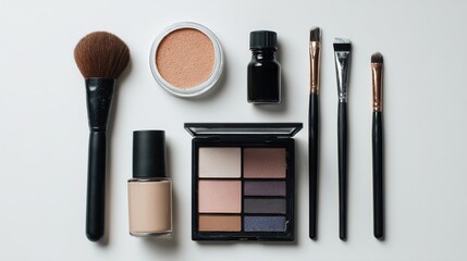 A flat lay of various makeup products including foundation, eyeshadow, blush, and brushes, showcasing an array of colors and tools for beauty enthusiasts.