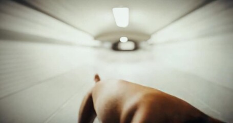 A boxer dog's tail in motion as it runs through a subway tunnel with blurred background - Powered by Adobe