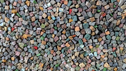Colorful small stones arranged in a random mosaic pattern for decorative use