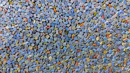 Vibrant assortment of small, colorful mosaic tiles creating a textured pattern