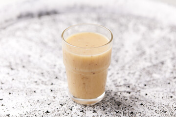 Pineapple coconut smoothie on bright background. Soft focus. Copy space.