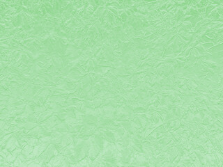 A subtly textured mint green surface