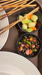 Asian Appetizer Tray with Melon, Carrot, and Spicy Vegetable Mix in Bowls – Overhead Food Presentation