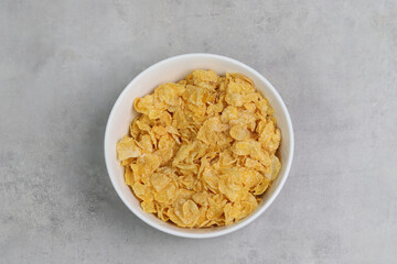 
Yellow frosted corn flakes bowl for dry, cereals breakfast. Healthy food.