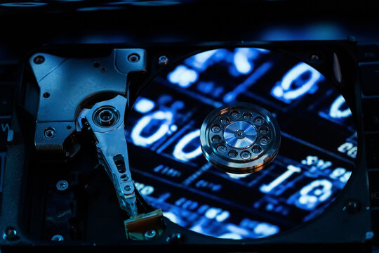 A hard disk with a blue binary code - Powered by Adobe