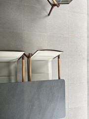 Top-Down View of Minimalist Table and Chairs on Tiled Floor – Modern Interior Design Concept