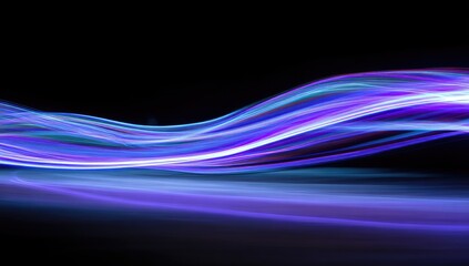 Abstract light streaks flowing over a dark surface