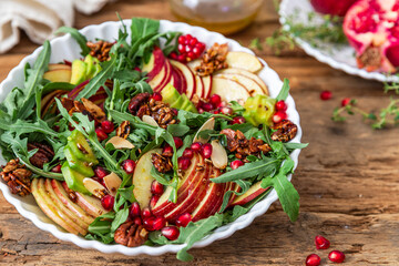 Autumn salad with apple, pomegranate, nuts and honey