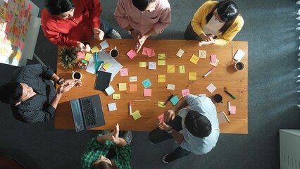 Time lapse of business team choose brainstorming idea and stick sticky notes at whiteboard. Group of diverse people working together sharing idea by using notes and equipment at table. Convocation.