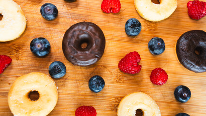 Beautifully styled donut platter featuring chocolate glazed, sugar dusted, blueberry and raspberry donuts. Perfect for bakery marketing, food blogs and party styling