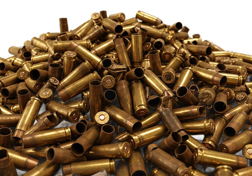 A large pile of used brass rifle ammunition casings scattered in a chaotic heap isolated on transparent background