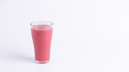 Fresh pink guava juice in a clear glass on a white background with copy space. Healthy tropical drink, rich in vitamin C, perfect for detox, wellness, and a refreshing lifestyle.
