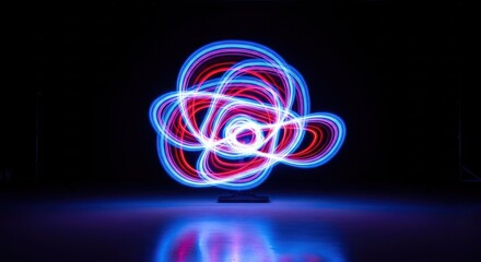Light painting swirling, intertwined red and blue lines against black