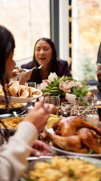 Friendsgiving - friends gathering for a traditional thanksgiving turkey dinner