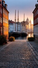Sunset Illuminating Cobblestone Street With Colorful Buildings By The Harbor