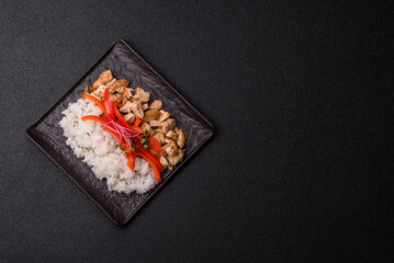 Bowl with chicken pieces, rice, tomatoes, peppers and microgreens. Bowl with chicken