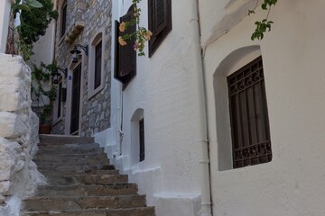 A narrow street with white buildings and stone steps is captured A narrow street with white buildings and stone steps in old Marmaris - Mugla - Turkey

