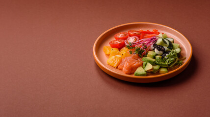 Bowl with salmon pieces, cheese, tomatoes, peppers and avocado. Salmon bowl