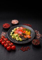 Bowl with salmon pieces, cheese, tomatoes, peppers and avocado. Salmon bowl