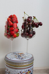 still life with two glasses with cherries and strawberries