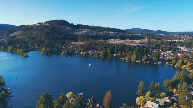 Langford Lake in British Columbia, Canada, offers a breathtaking aerial view of its serene waters and surrounding lush greenery, ideal for outdoor activities.